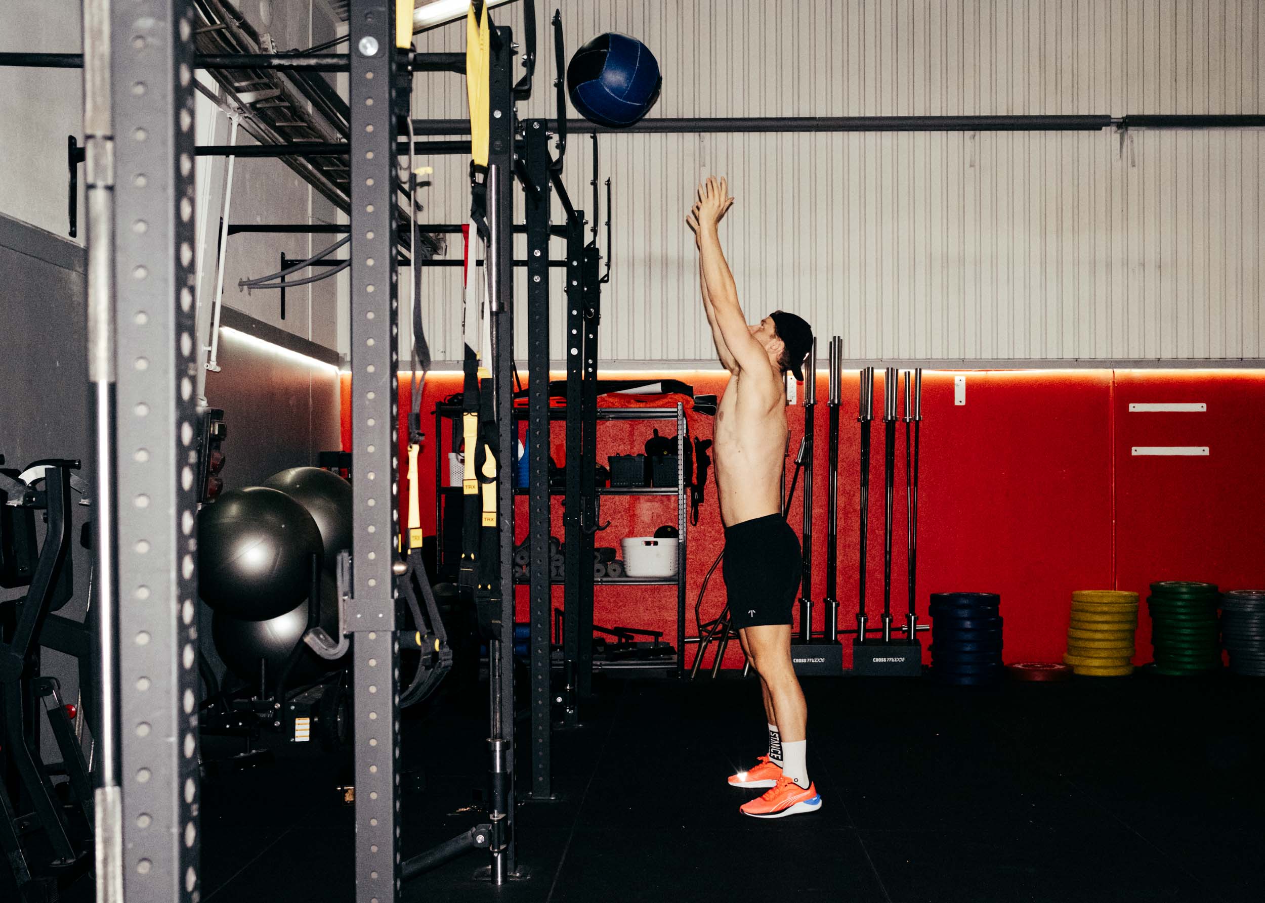 A man doing wall balls in TOQO shorts