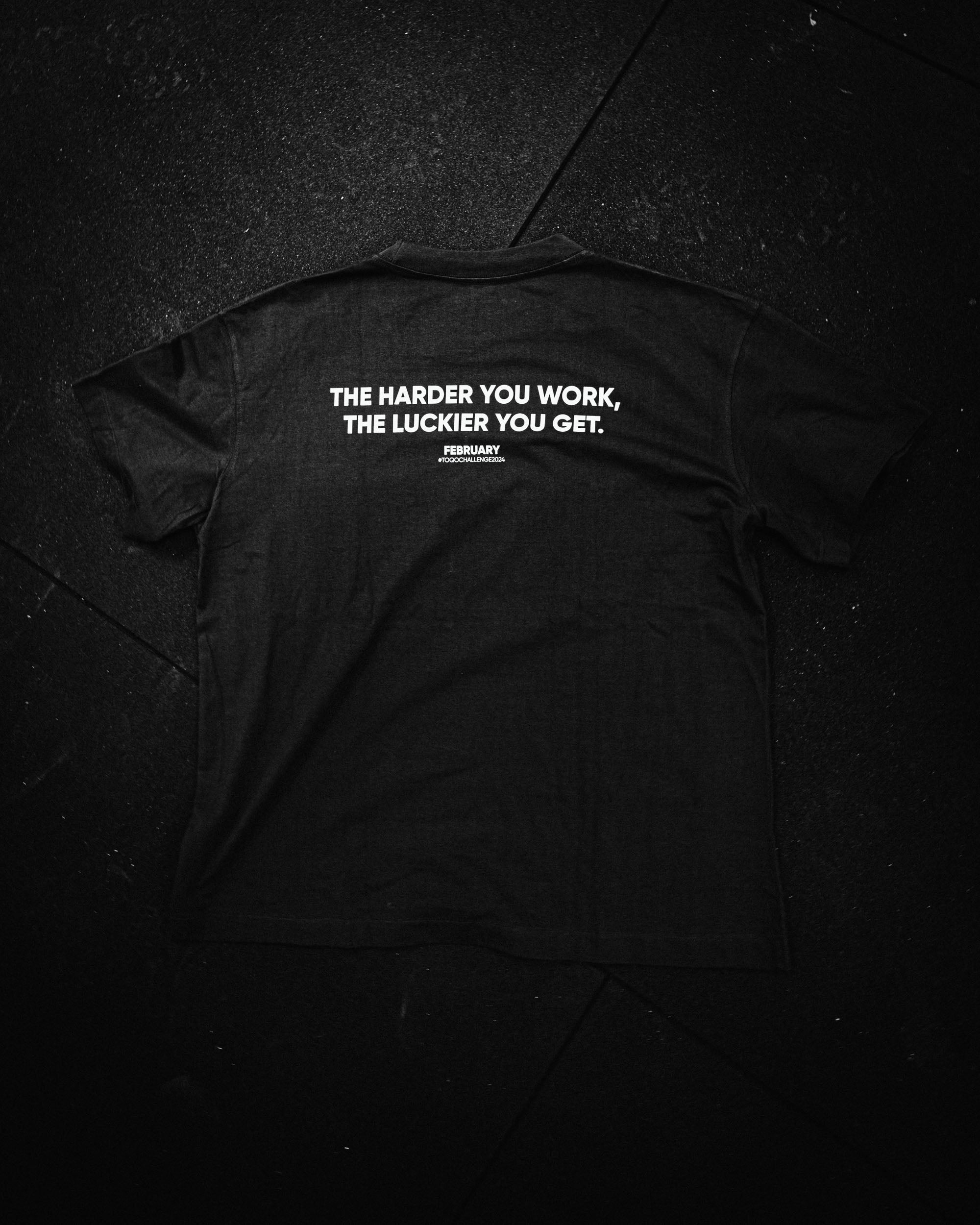 A black TOQO t - shirt with qoute