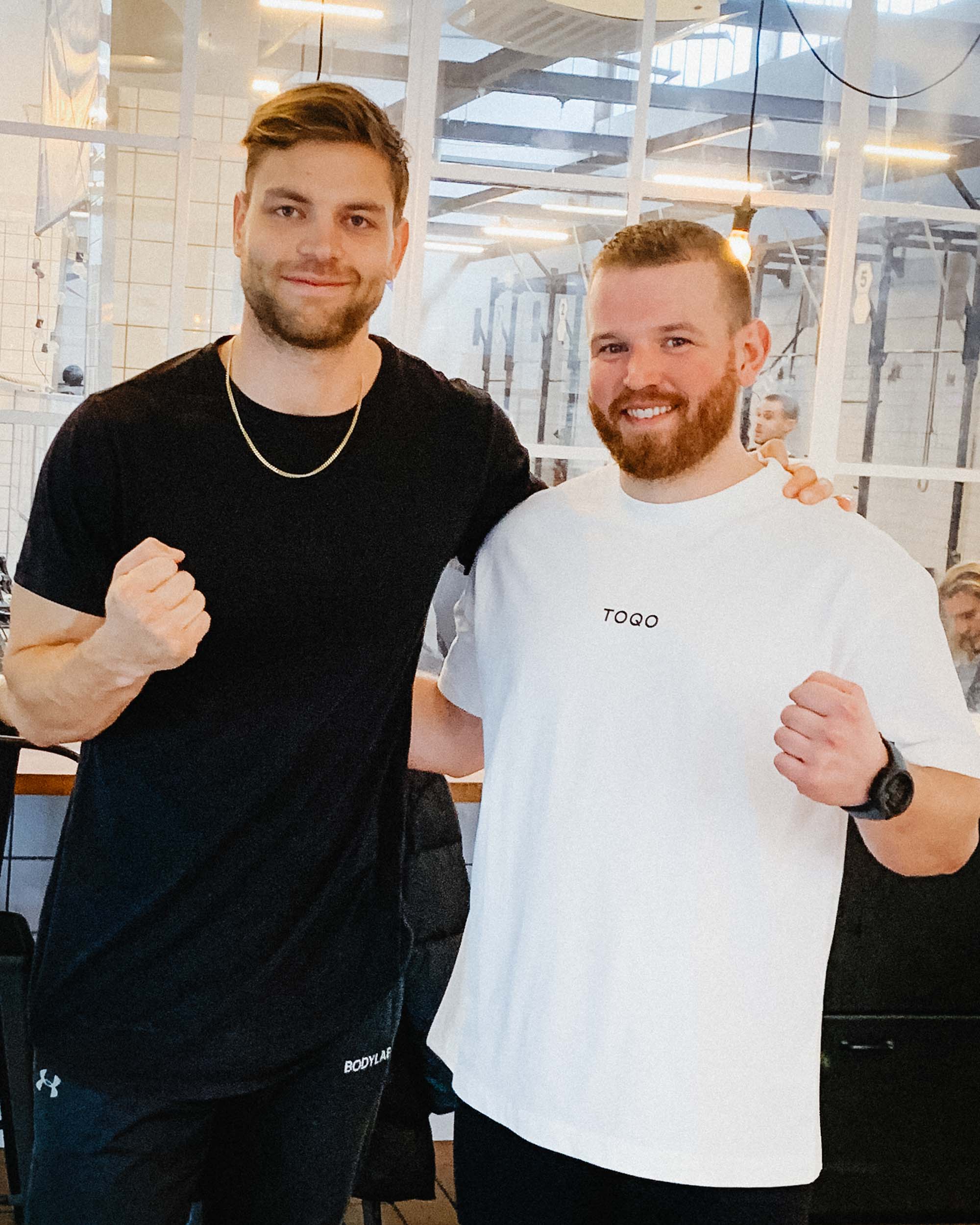 A man standing in a TOQO shirt