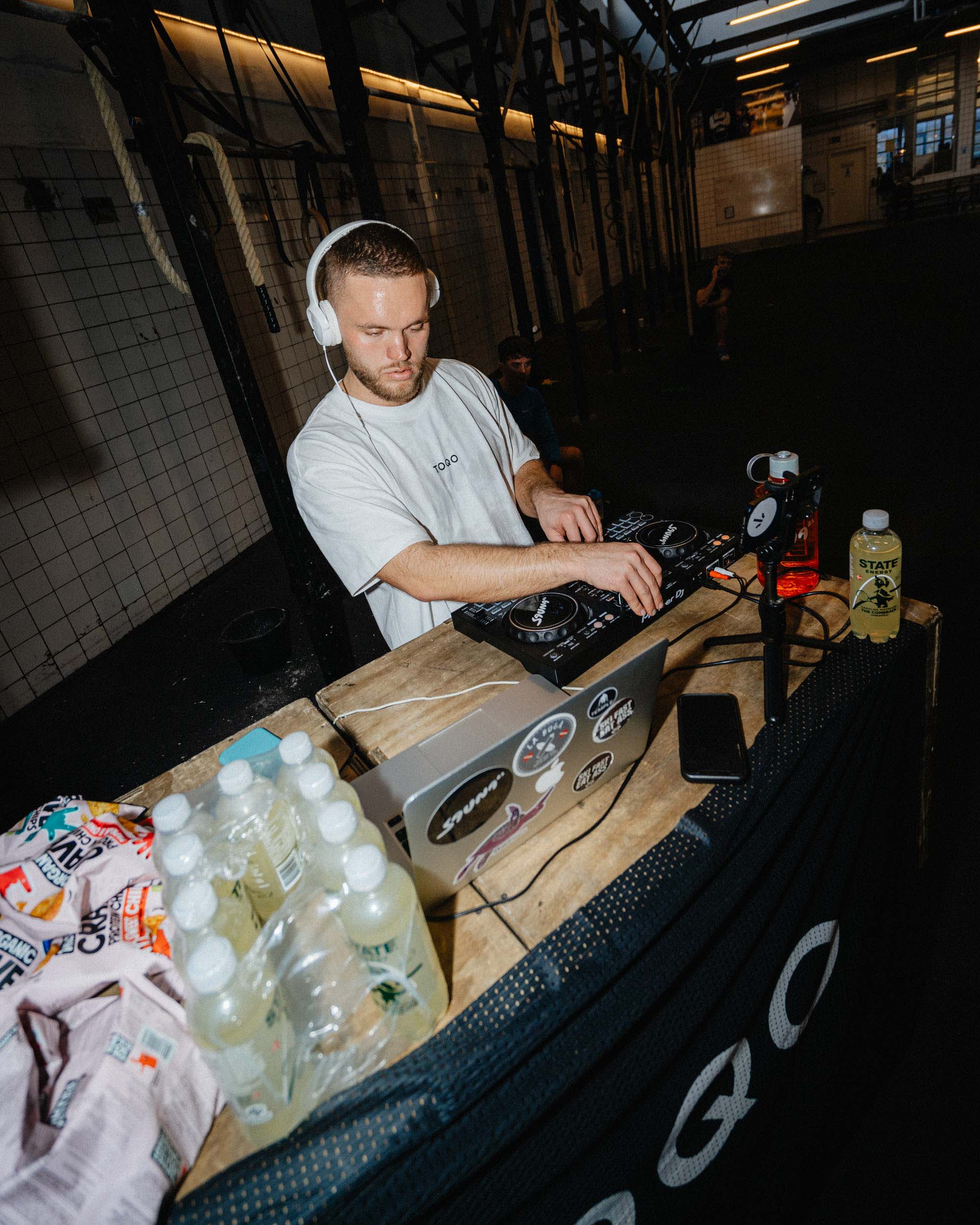 A man DJing in a TOQO shirt