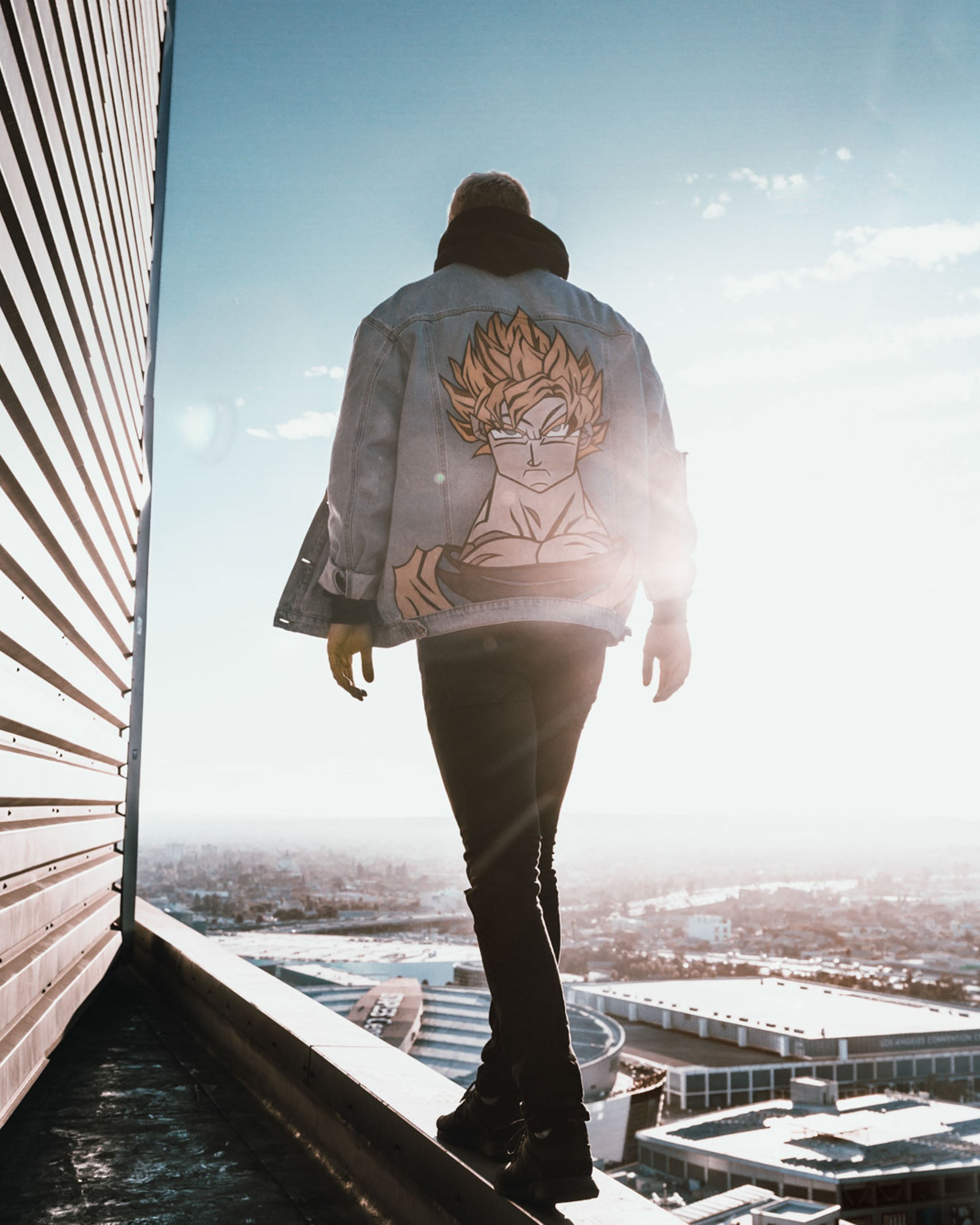 A man walking at the edge of a building