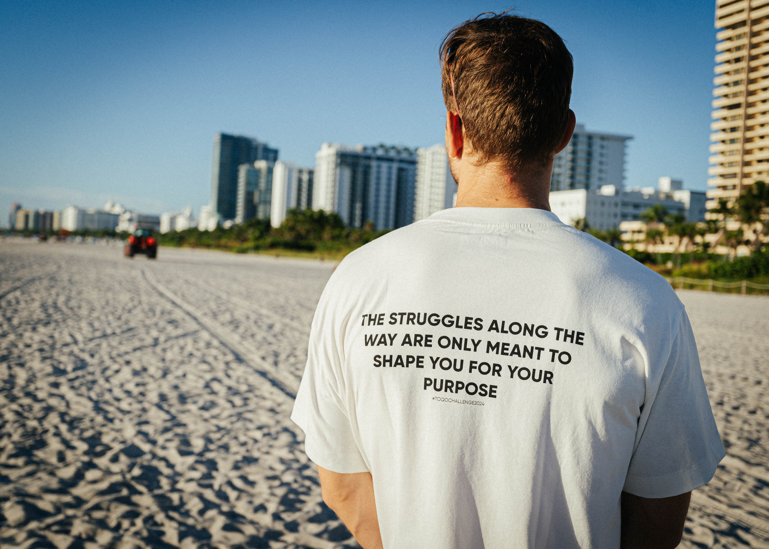 A man in a TOQO shirt at the beach