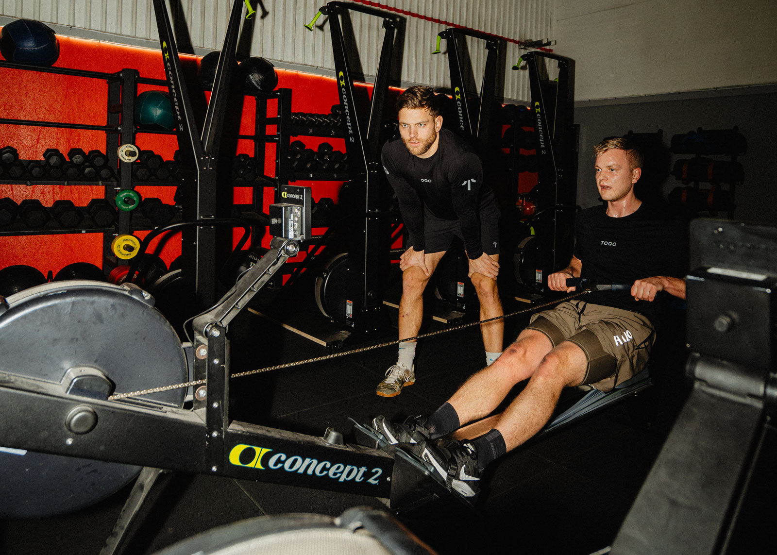 Two men working out on the rowing machine