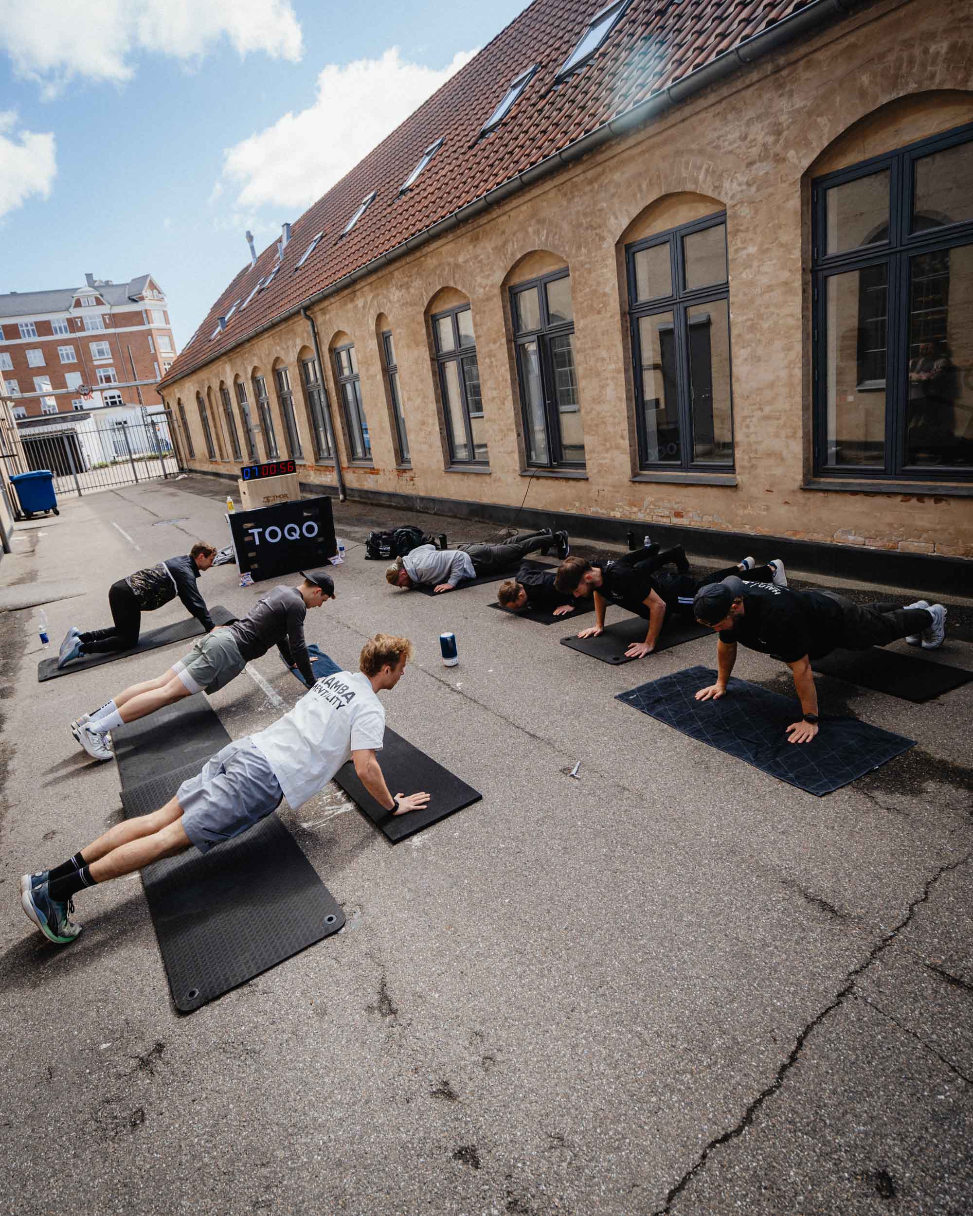 A group of men doing push ups