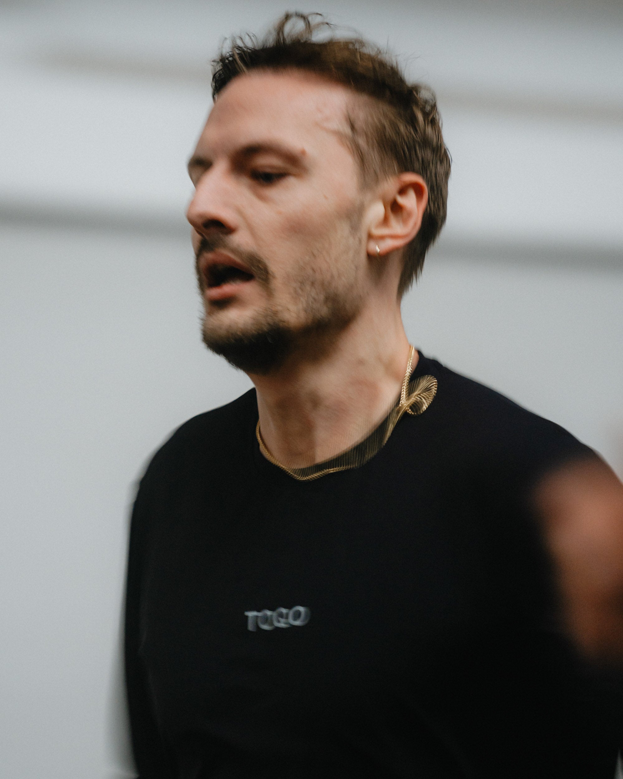 A man doing the beep test in TOQO clothes