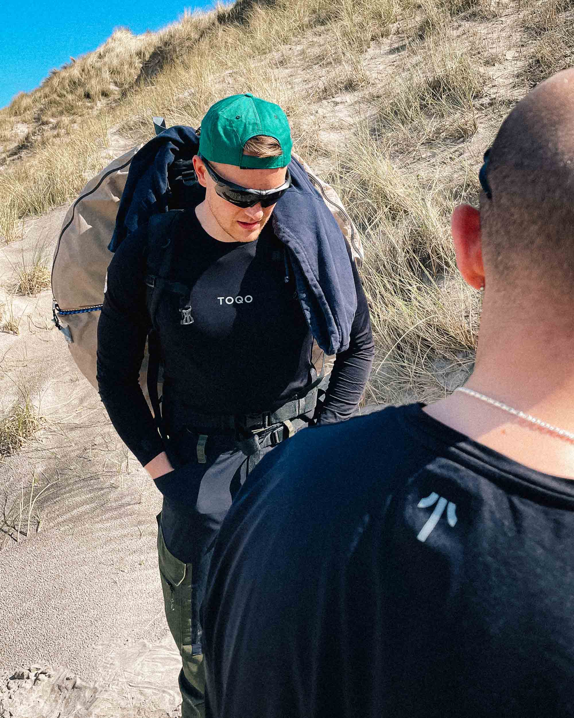 A man on a beach in TOQO clothes